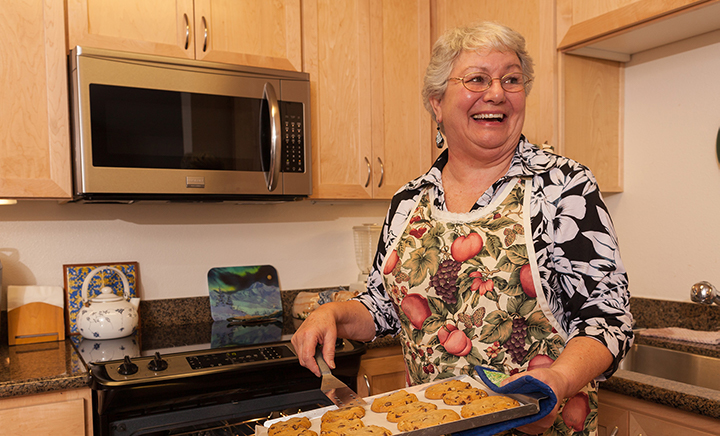 resident-baking-fresh-cookies-in-her-home-720x436