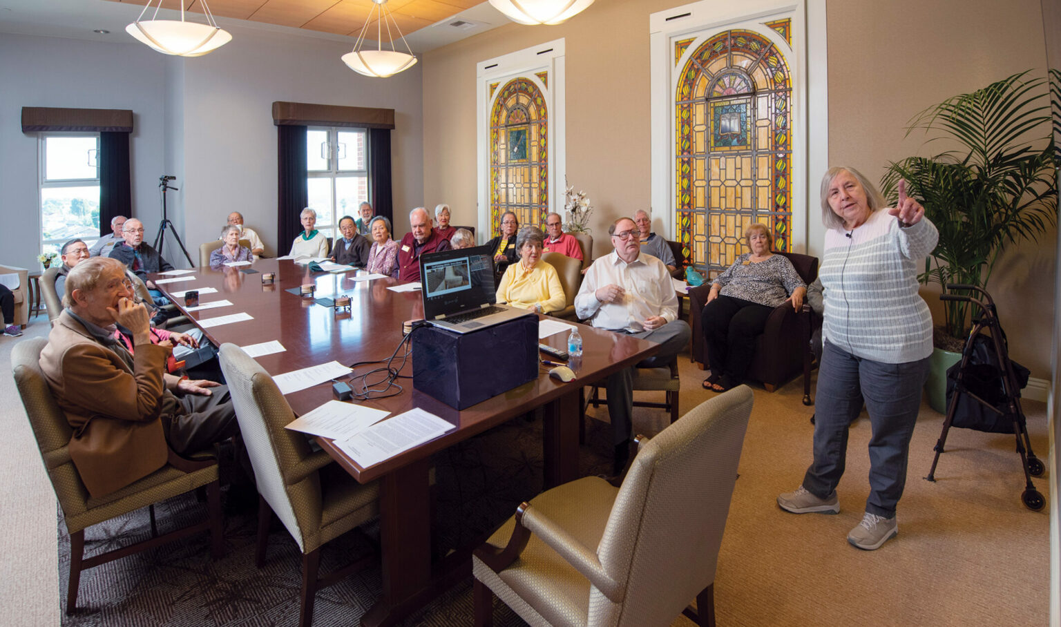 Residents and visitors at Acacia Creek Retirement Community listen during a senior living presentation.